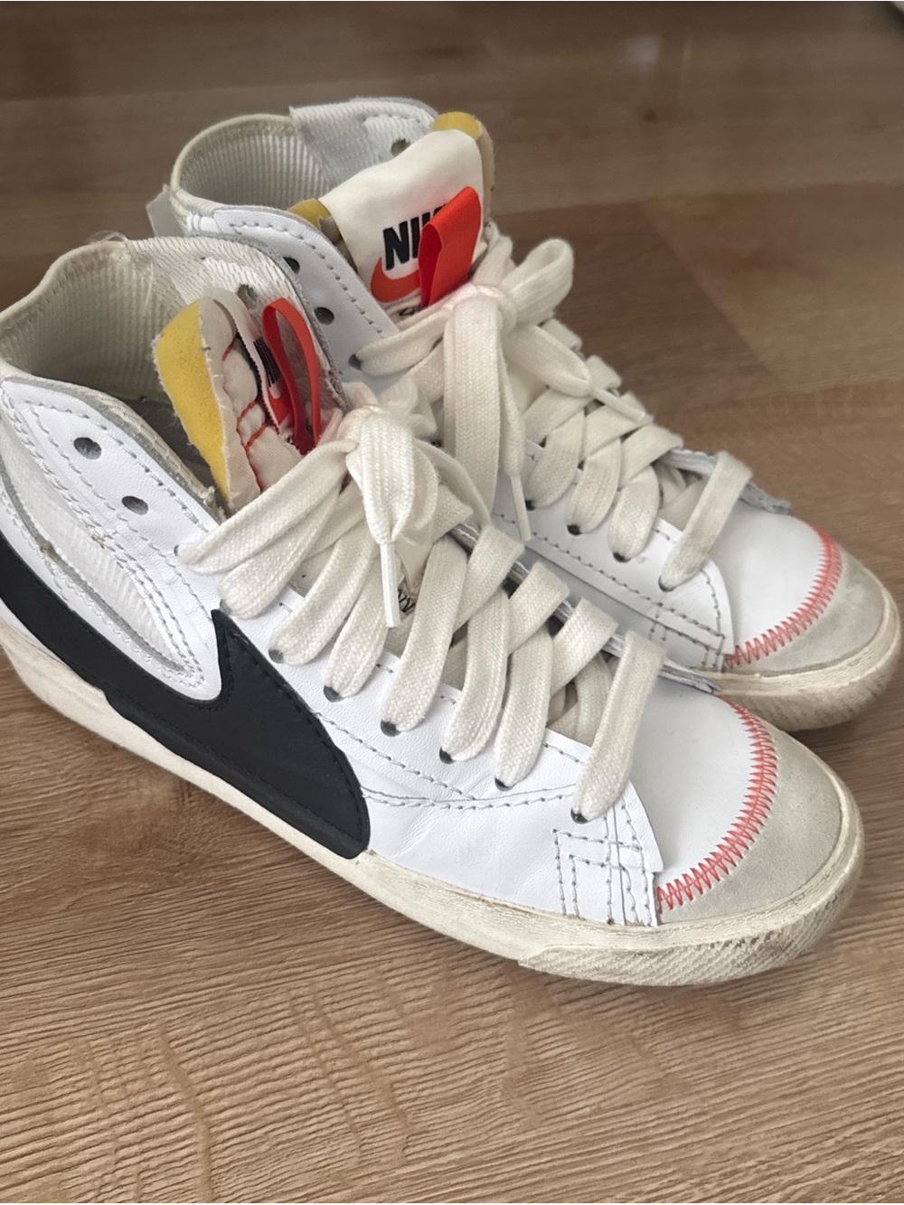 Nike White High-Top Sneakers with Black Swoosh and Red Stitching
